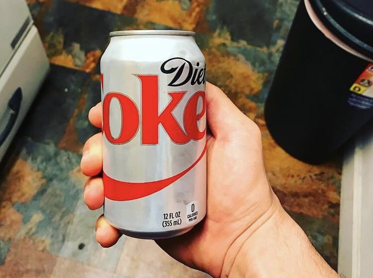 Person holding diet soda