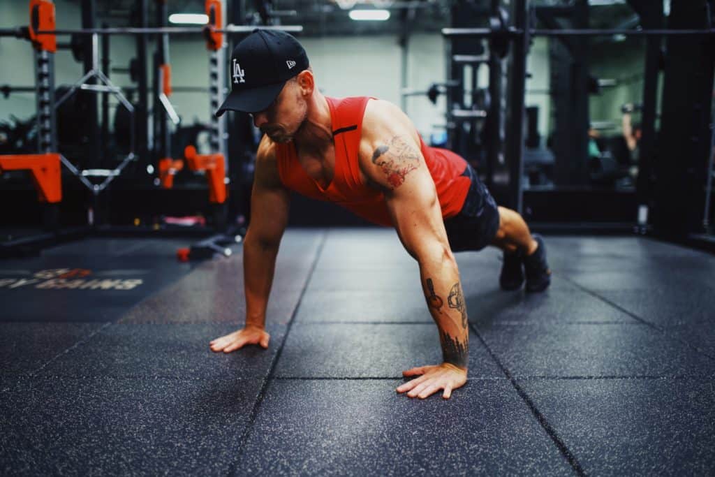 Man performing pushups in a gym